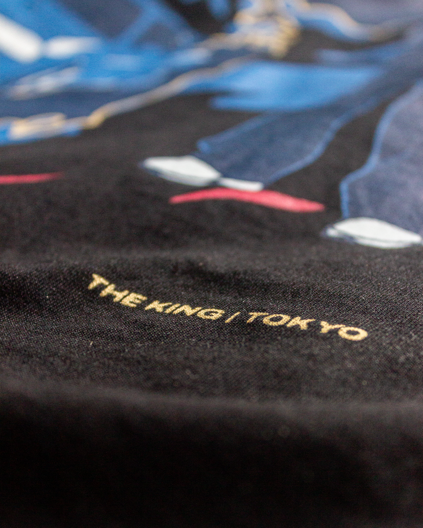 Close-up of Velentia black Tokyo T-shirt showing detailed motorsport inspired graphic print