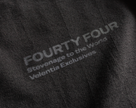 Close-up of Velentia black Tokyo T-shirt showing detailed motorsport inspired text graphic screen print