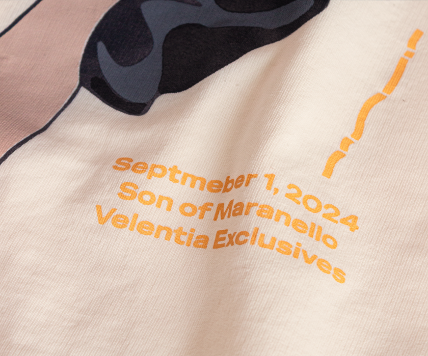 Close-up of Velentia cream Monza September T-shirt showing detailed motorsport inspired graphic print