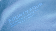 Close-up of Velentia summer sky blue Tokyo T-shirt showing detailed motorsport inspired text graphic print