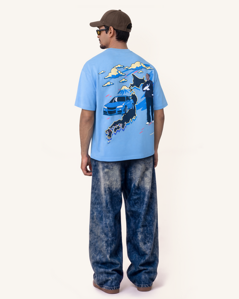 Model wearing Velentia summer sky blue Tokyo graphic T-shirt with relaxed oversized fit, from the back